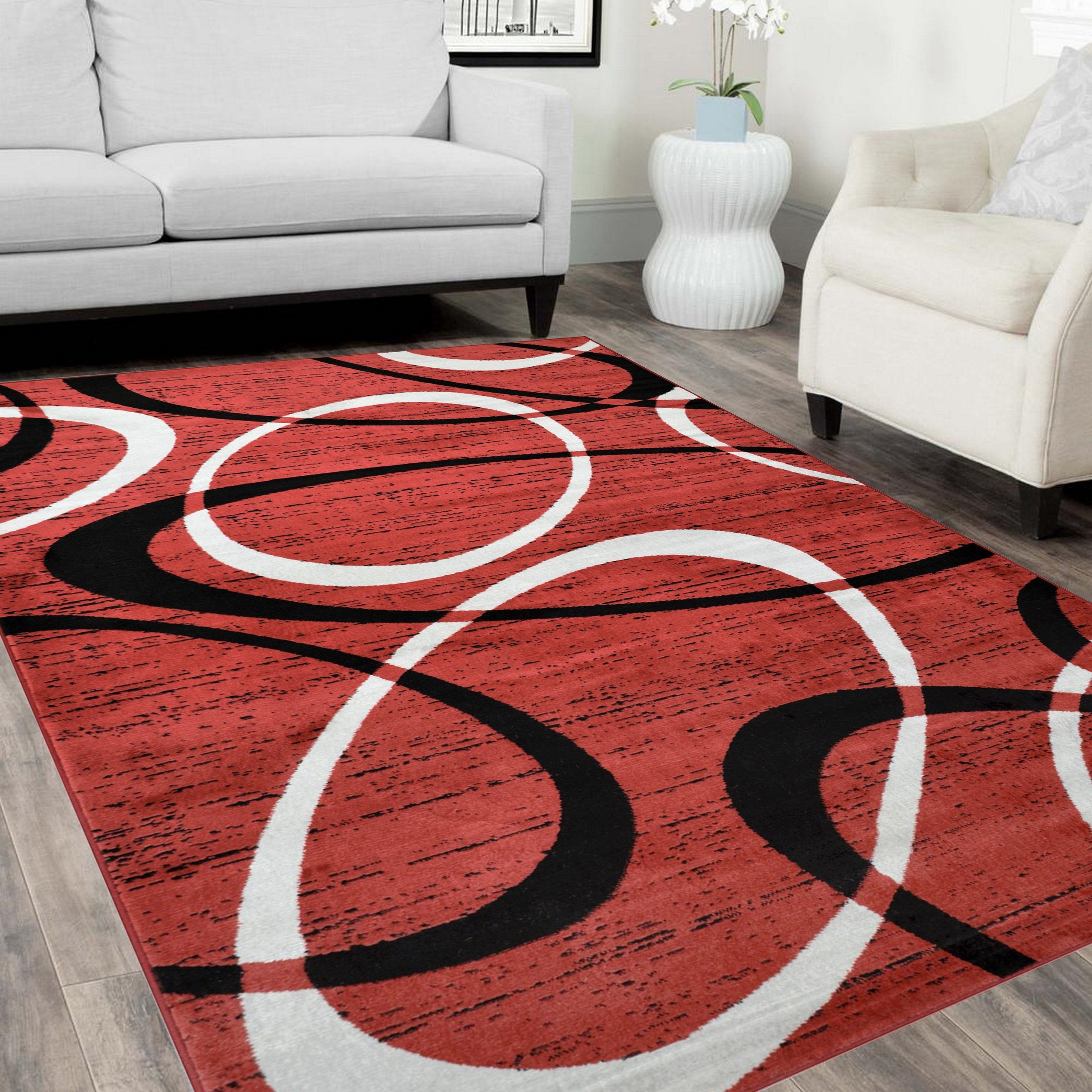 Soft-touch oval pattern rug in gray, red, beige, and blue.